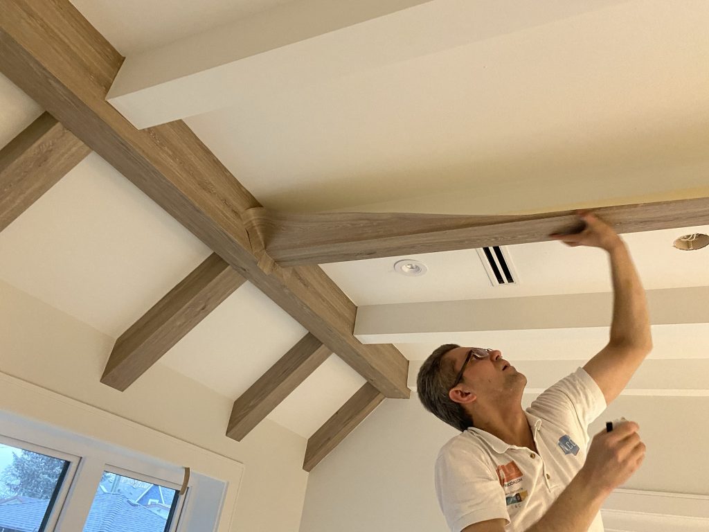 A man installing Faux wood 