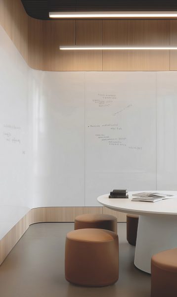 A large-scale university classroom featuring seamless wall-to-wall dry-erase surfaces installed with Bodaq Easy Clean architectural film.